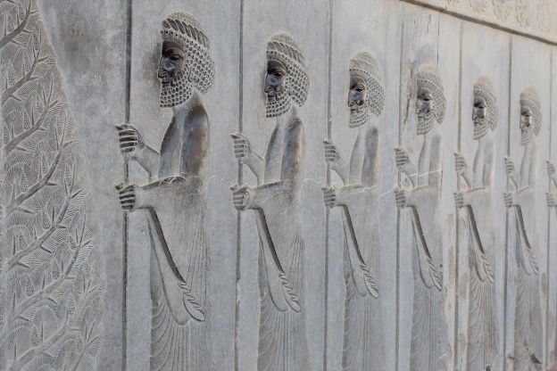 Wall carving of people in procession, from the ancient city of Persepolis, which had been the capital of the Achaemenid Empire.