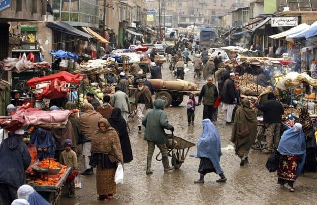 Busy street scene at outdoor Afghan market.