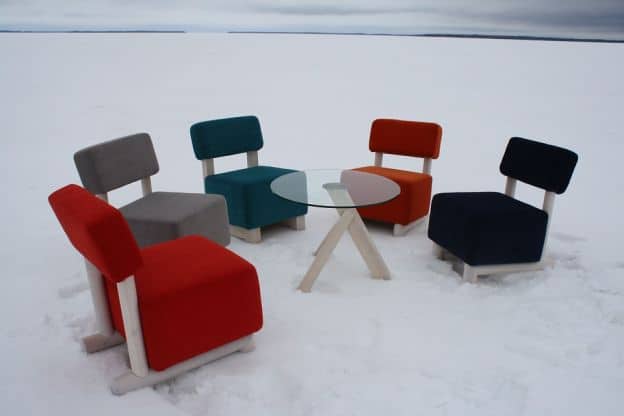 A circle of upholstered chairs sits on the frozen Oulu lake. There are no people in the picture.