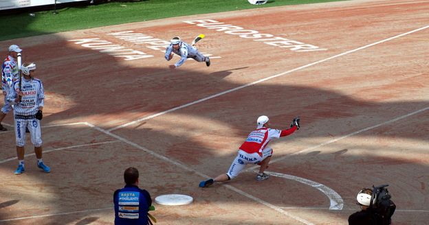 Two teams compete in a Finnish game similar to American baseball on a field that looks somewhat like a baseball diamond.